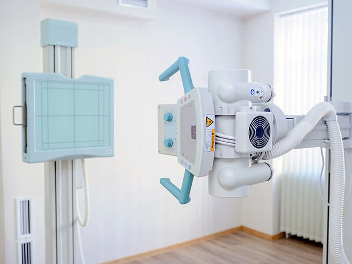 Close up view of white x-ray machine in a radiology room
