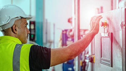 factory engineer staff pressing Emergency Stop Switch machine malfunctioning for safety