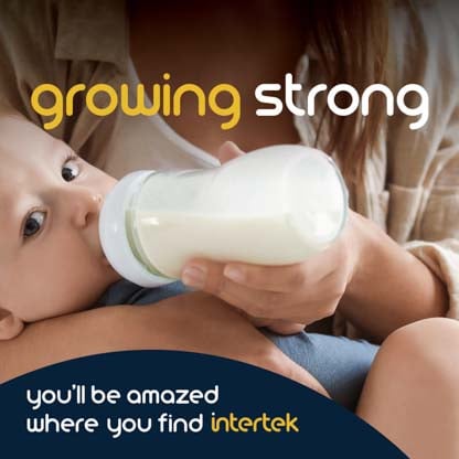 An infant being fed milk from a bottle