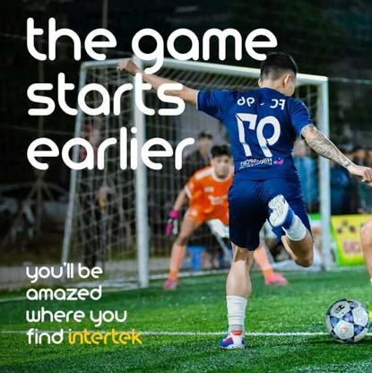 A footballer about to kick the ball into the net